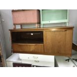 A teak sideboard with glass doors