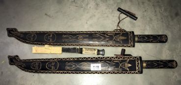 Two collectors wall hanging machetes