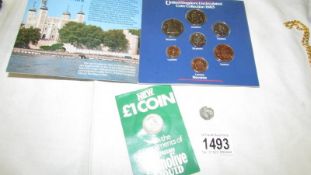 A hammered silver coin, a UK coin set and a new £1 coin.