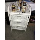 A wicker 3 drawer bathroom cabinet