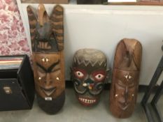 3 carved wall masks.