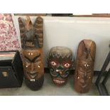3 carved wall masks.