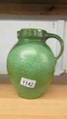 A green pottery jug marked Liberty, Made in England,