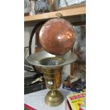 A copper pan and a large brass urn/planter.