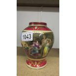 A hand painted vase with classical scenes.