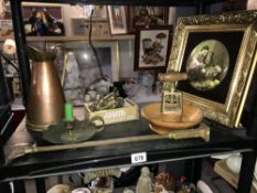 A shelf of old brassware including old chamber candlestick etc.