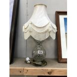 A cut glass table lamp with shade