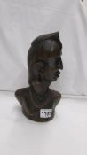 A carved wood African male bust.