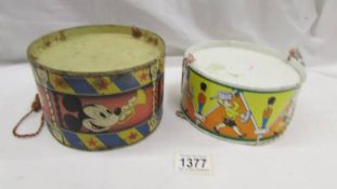 2 tin drums including Mickey Mouse.