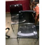 A pair of retro chrome and plastic chairs