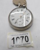 A silver pocket watch inscribed I W Benson, London, hall marked for London 1886 with key.