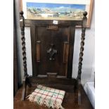 A carved wood fire screen with barley twist side columns