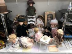 A collection of dolls including porcelain example & a Chiltern black baby doll