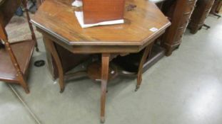 An octagonal inlaid table, water stains to top.