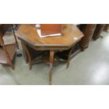 An octagonal inlaid table, water stains to top.