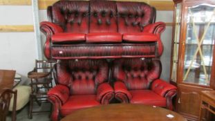 A red leather three piece suite.