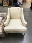 A cream leather arm chair.