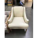 A cream leather arm chair.