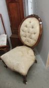 A Victorian mahogany framed nursing chair.