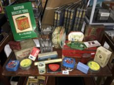 A collection of collectors tins and book on biscuit tins
