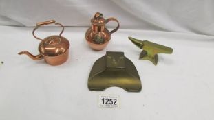 A miniature copper teapot, miniature copper flagon, miniature brass anvil and a brass inkwell.