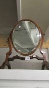 A mahogany toilet mirror.