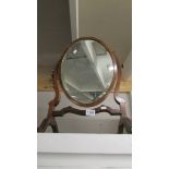 A mahogany toilet mirror.