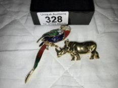 An enamelled parrot brooch & a yellow metal rhino brooch