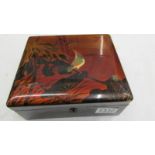 A nice lacquered box decorated with an exotic bird.