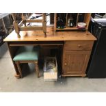 A pine desk and stool.