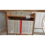A Peter Rabbit bookcase with 24 Peter Rabbit books.