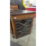 An astragal glazed mahogany corner cabinet with shaped shelves.