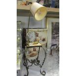 A retro alarm clock/lamp and a wrought iron stand with tiled top.