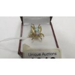 A 2 stone yellow gold ring shaped as a fly and set 2 opals, size N half.