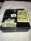 A small cash tin with some contents