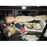 A shelf of old dolls including tray of miniature dolls house items