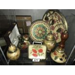 A shelf of enamelled brass