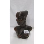 A carved wood African bust of a female.