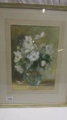 A framed and glazed watercolour of a vase of white flowers, initialled A M S. 84.