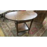 An oval inlaid drop side table on castors (central inlay a/f).