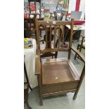 A commode chair complete with pot.