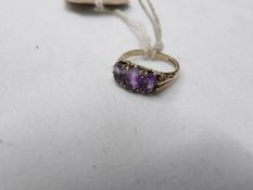 An amethyst set 3 stone ring dated London 1990 in 9ct gold, hall marked. size J half.