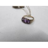 An amethyst set 3 stone ring dated London 1990 in 9ct gold, hall marked. size J half.