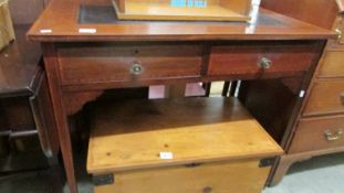 An inlaid writing table with leather inset top.