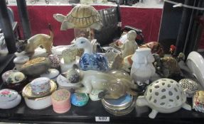 A shelf of lidded pin trays and figurines etc.