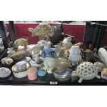 A shelf of lidded pin trays and figurines etc.