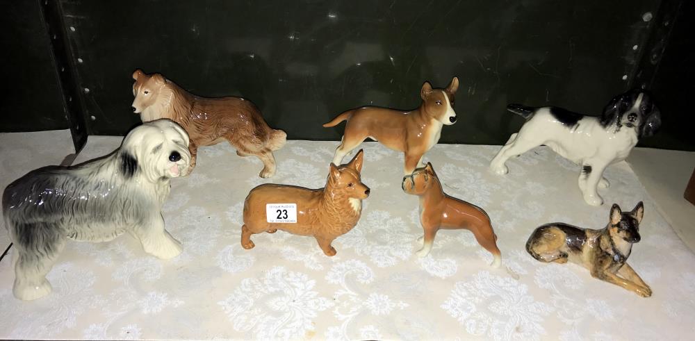 7 dog figures including Corgi & Spaniel etc.