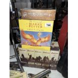 A selection of Harry Potter books and war videos