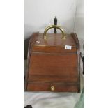 A mahogany coal box complete with liner and shovel, in good condition.