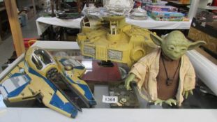 2 Star Wars space vehicles and a battery operated Yoda figure.